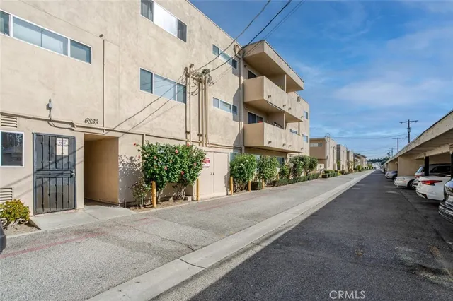 a view of a street with cars parked