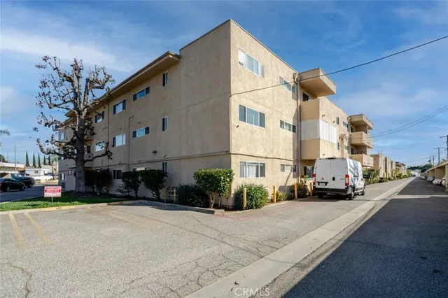 a cars parked in front of a white building