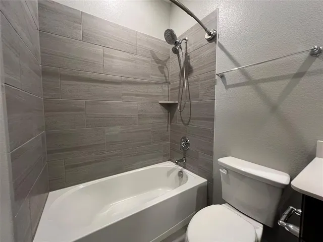 a bathroom with a toilet bathtub and shower