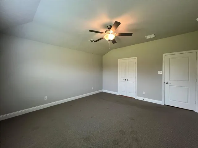 an empty room with a empty space and a ceiling fan
