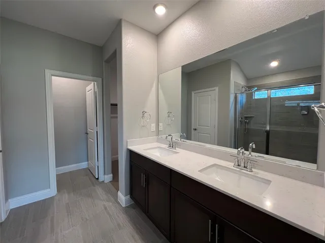 a bathroom with a glass shower door