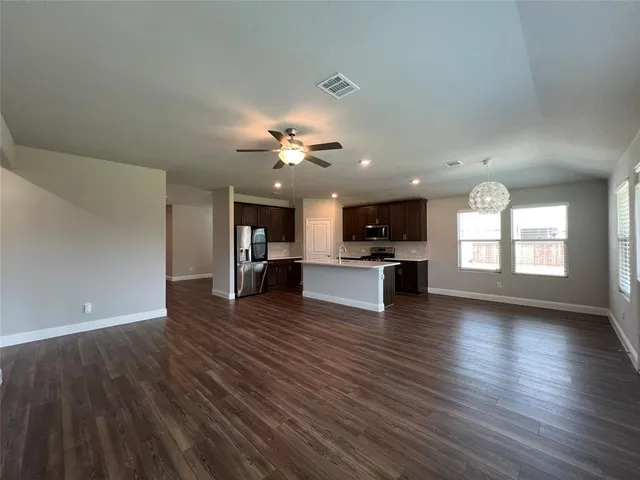 a view of kitchen with cabinets and wooden floor