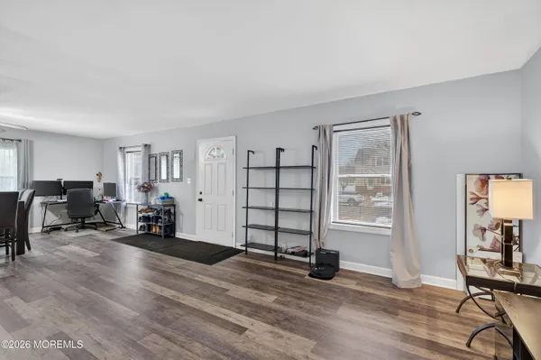 a view of a livingroom with workspace and a window