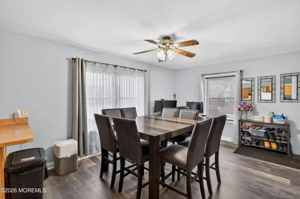 a view of a dining room with furniture and wooden floor
