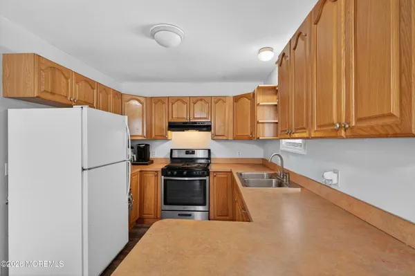a kitchen with a refrigerator a stove top oven a sink and dishwasher