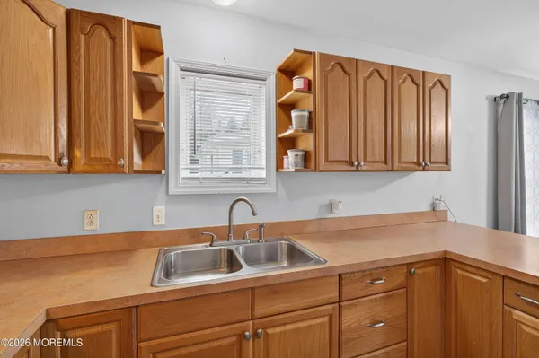 a kitchen with a sink cabinets and a window