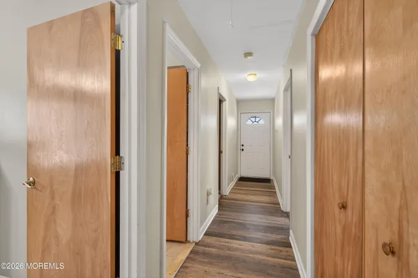 a view of a hallway with wooden floor
