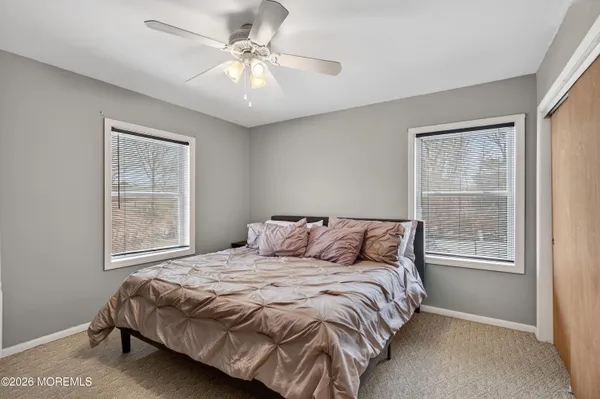 a bedroom with a large bed and a window