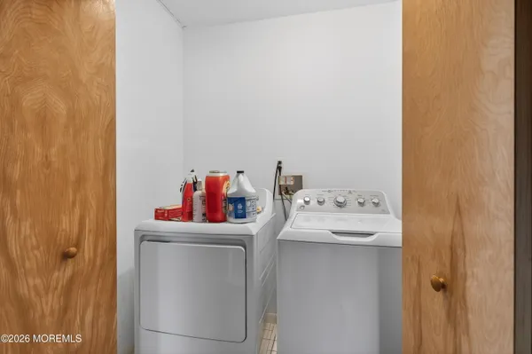 a bathroom with a sink and a refrigerator
