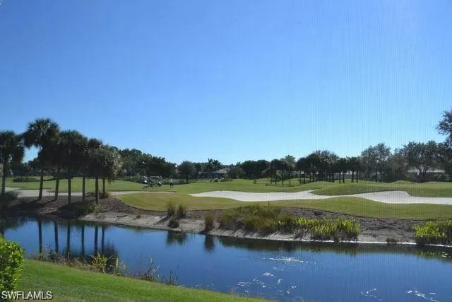 a view of a lake with a yard and trees