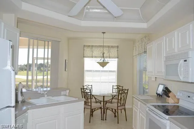 a kitchen with a table chairs and a window