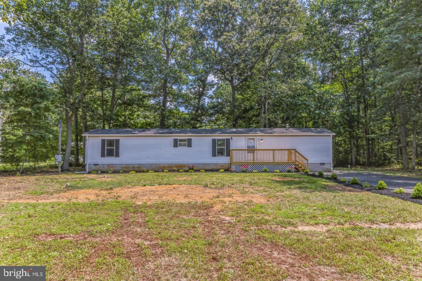 232 Jute Road Millville, NJ 08332 - Photo 1 of 30 a backyard of a house with large trees and a barn