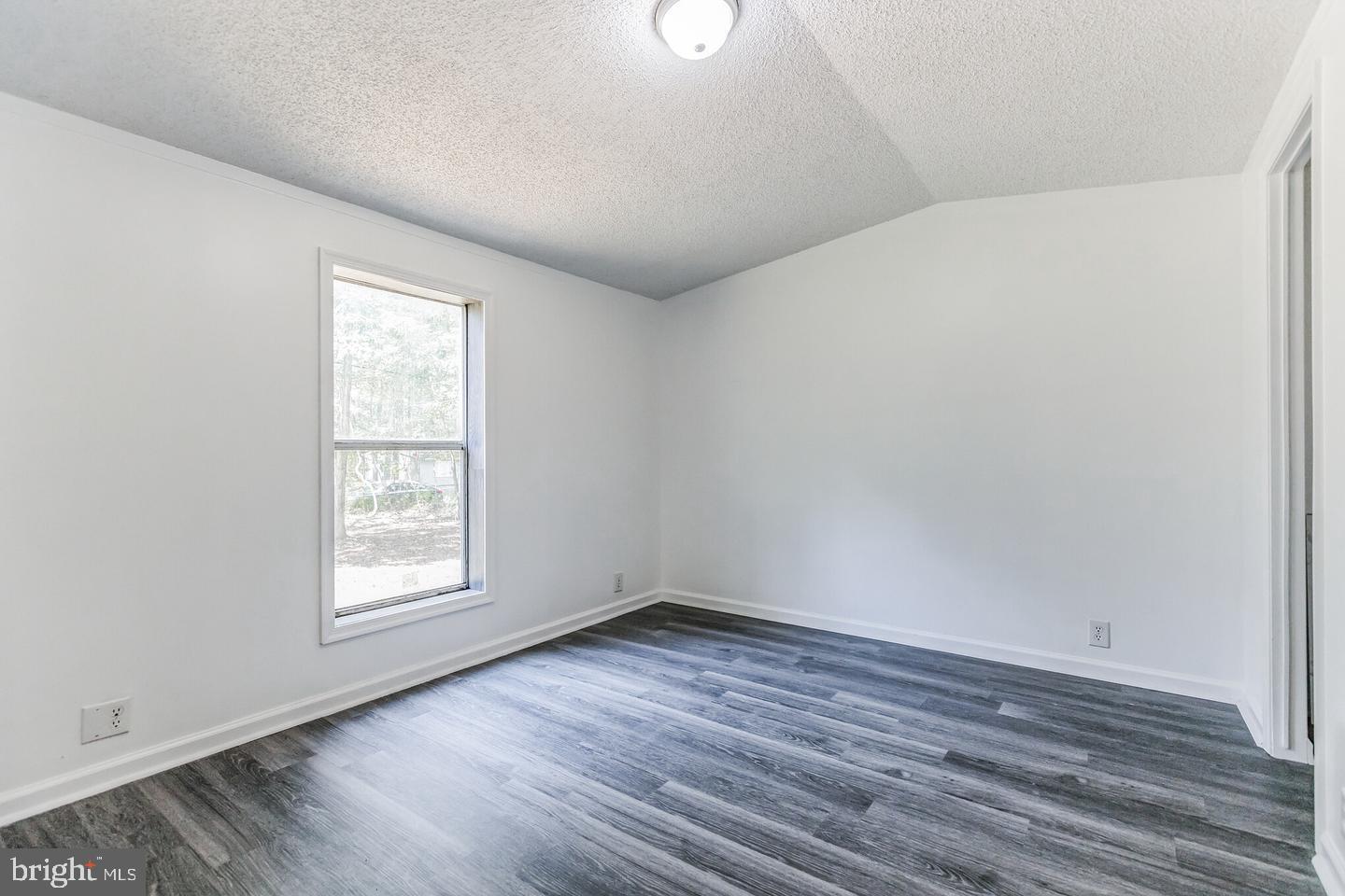 232 Jute Road Millville, NJ 08332 - Photo 13 of 30 an empty room with wooden floor and windows