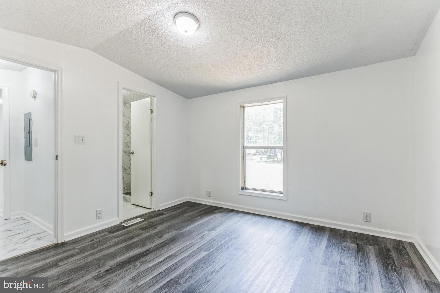 232 Jute Road Millville, NJ 08332 - Photo 19 of 30 an empty room with wooden floor and window