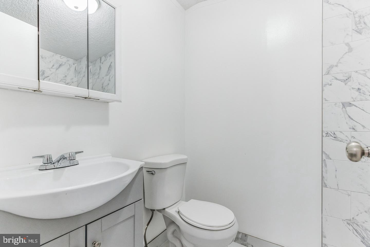 232 Jute Road Millville, NJ 08332 - Photo 21 of 30 a white toilet sitting next to a bathroom sink