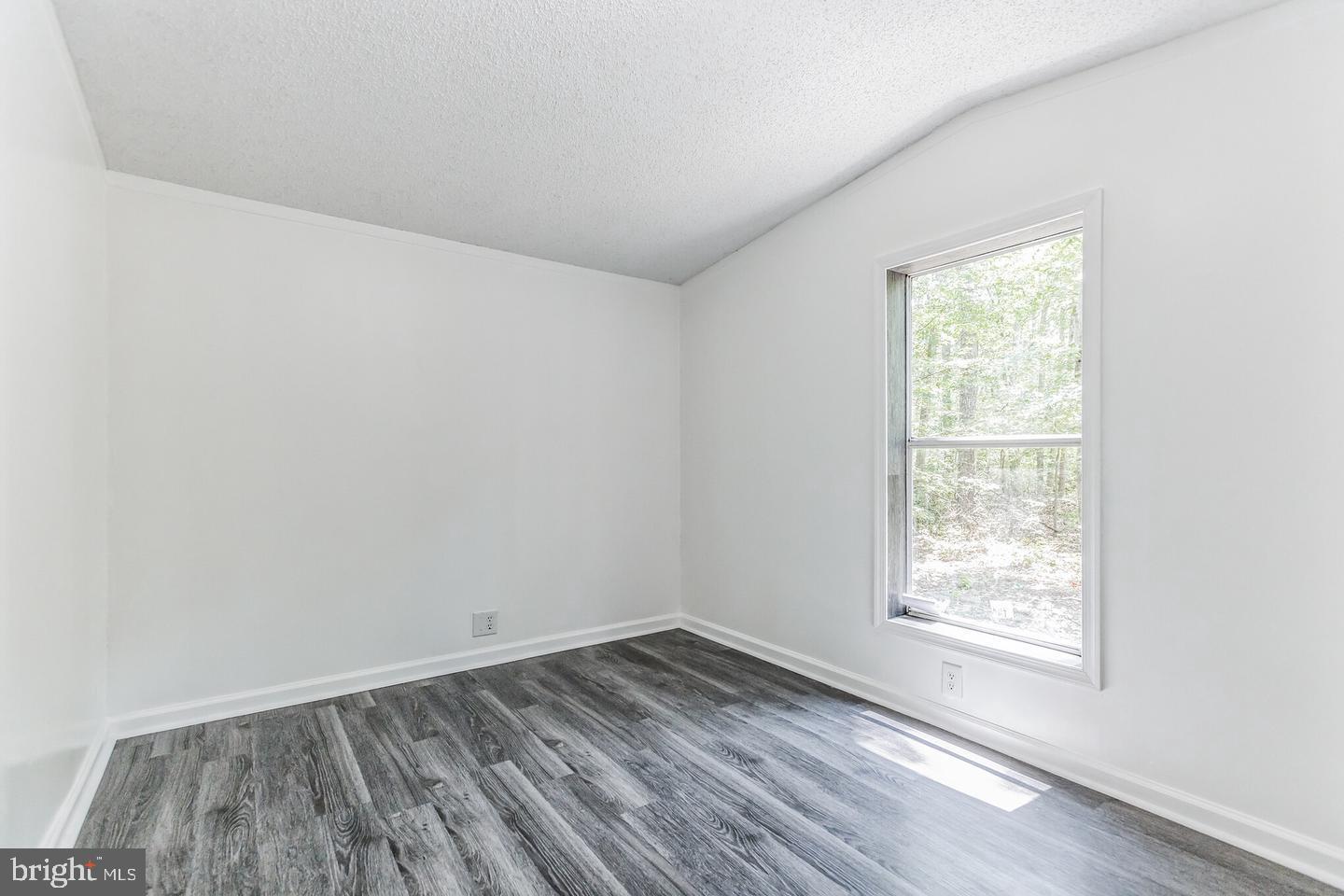 232 Jute Road Millville, NJ 08332 - Photo 24 of 30 an empty room with wooden floor and windows