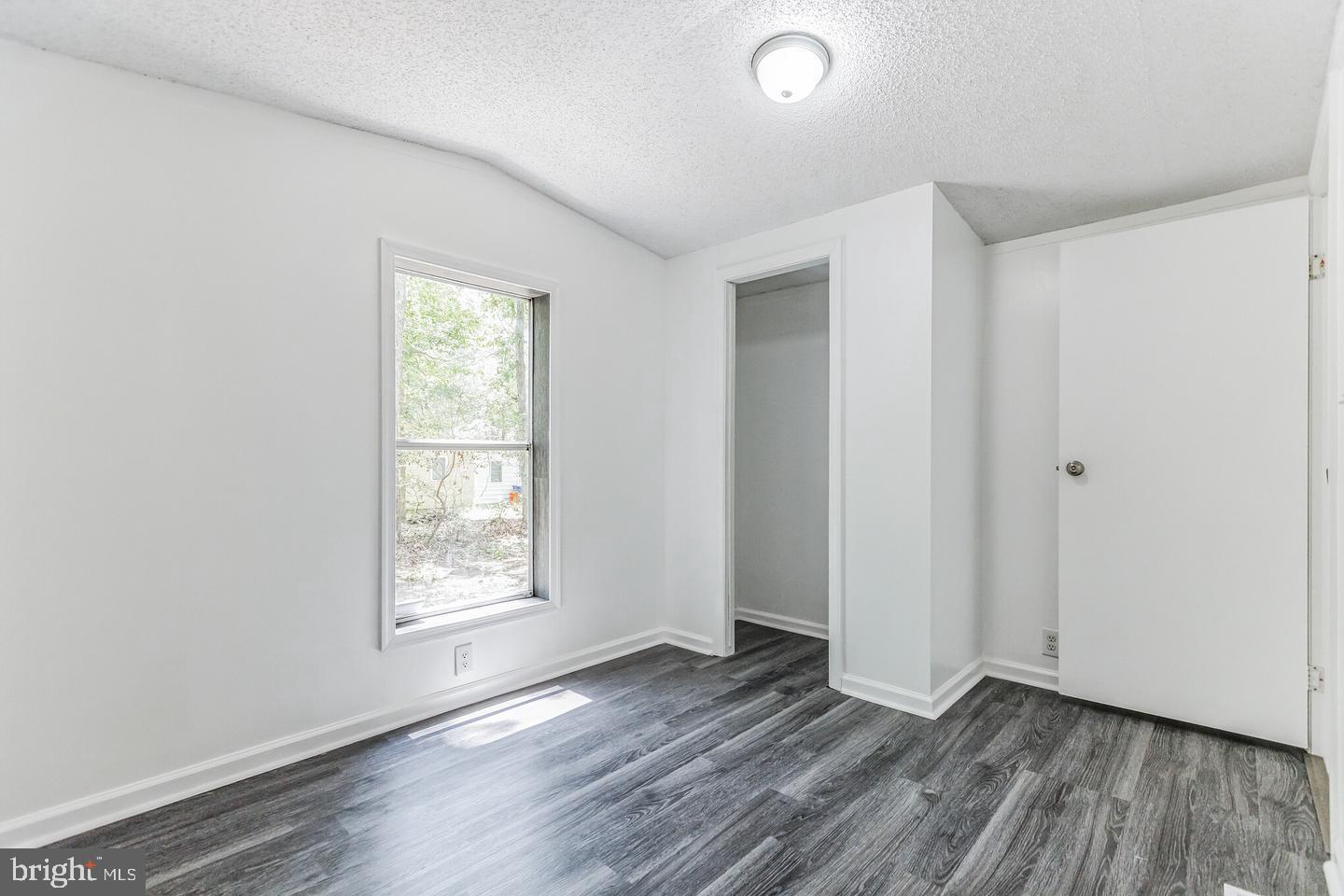 232 Jute Road Millville, NJ 08332 - Photo 26 of 30 an empty room with wooden floor and windows