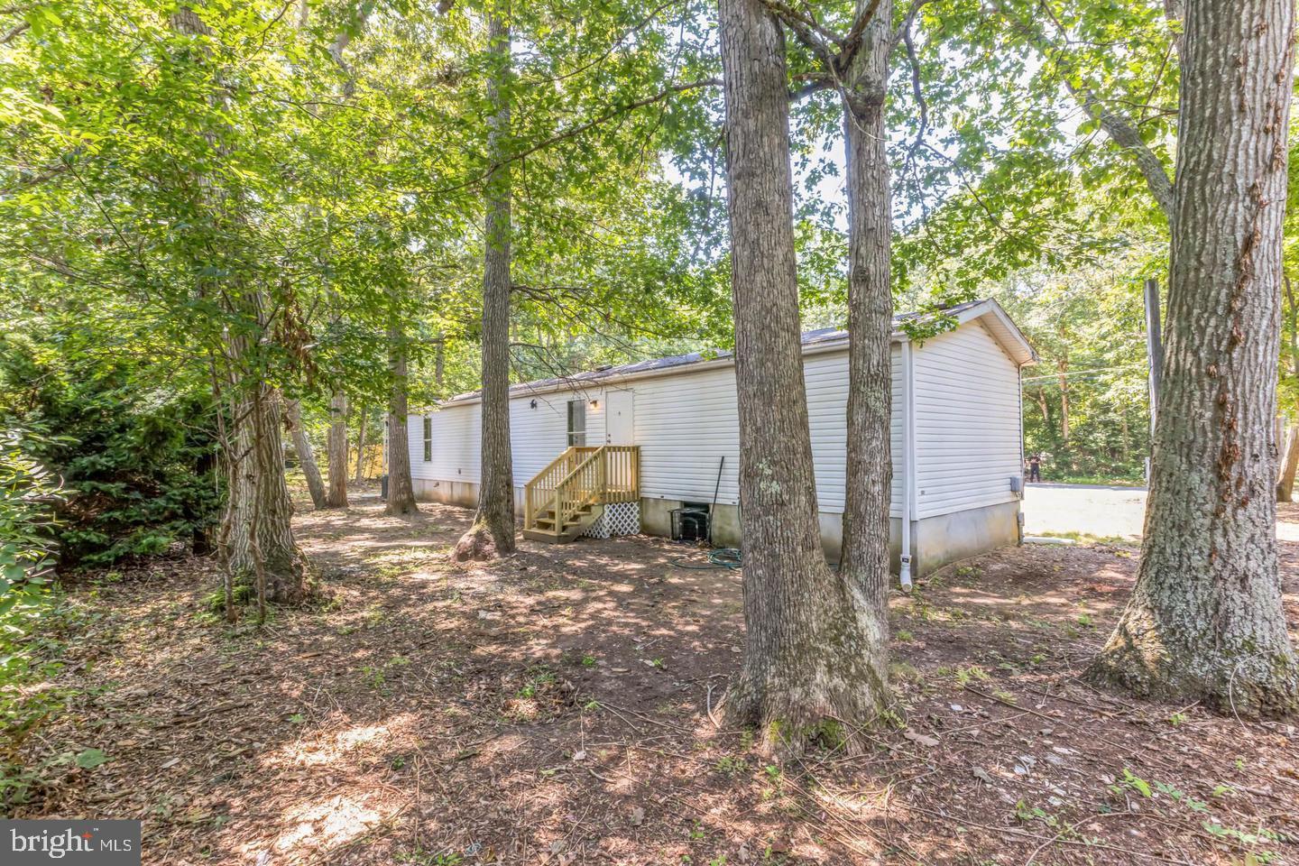 232 Jute Road Millville, NJ 08332 - Photo 29 of 30 a view of a house with large tree and wooden fence
