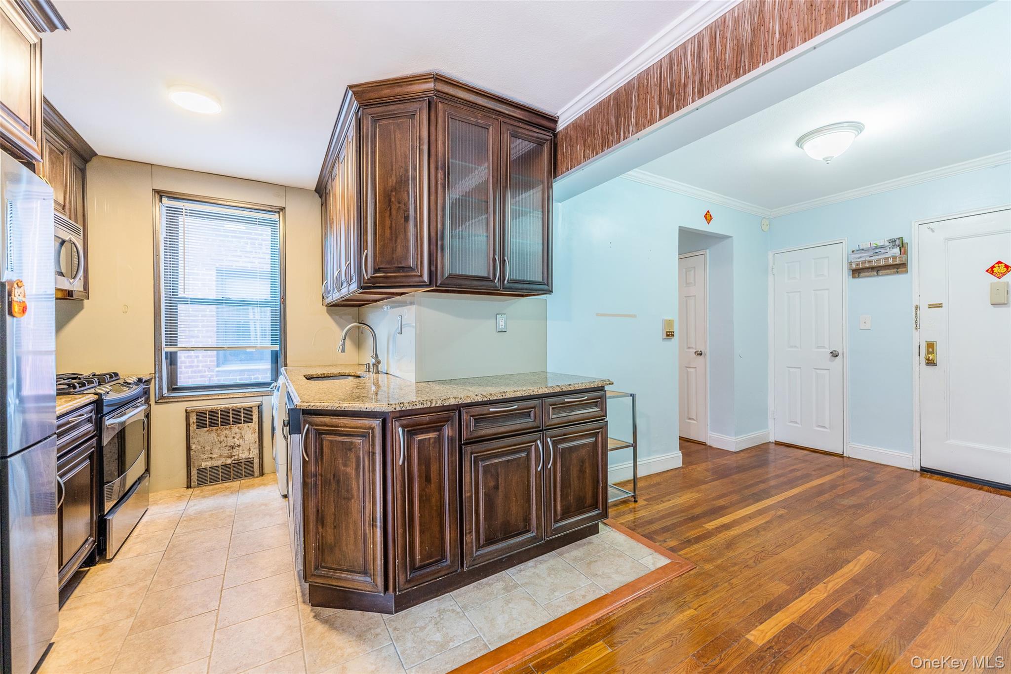 150-25 72nd Road, Unit 5K Queens, NY 11367 - Photo 12 of 21 a kitchen with stainless steel appliances granite countertop a stove and a sink