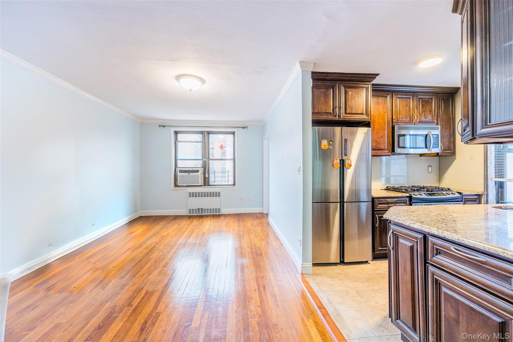150-25 72nd Road, Unit 5K Queens, NY 11367 - Photo 2 of 21 a kitchen with a refrigerator and a sink