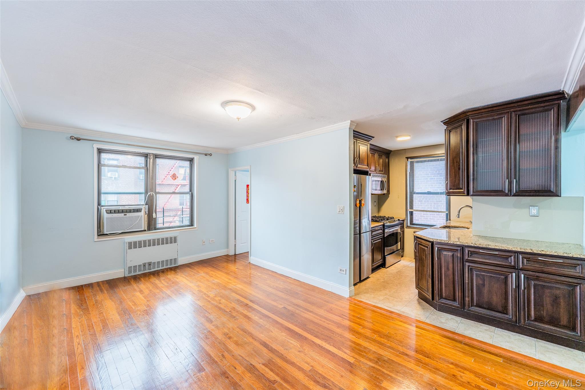 150-25 72nd Road, Unit 5K Queens, NY 11367 - Photo 3 of 21 a view of a kitchen with wooden floor and a sink