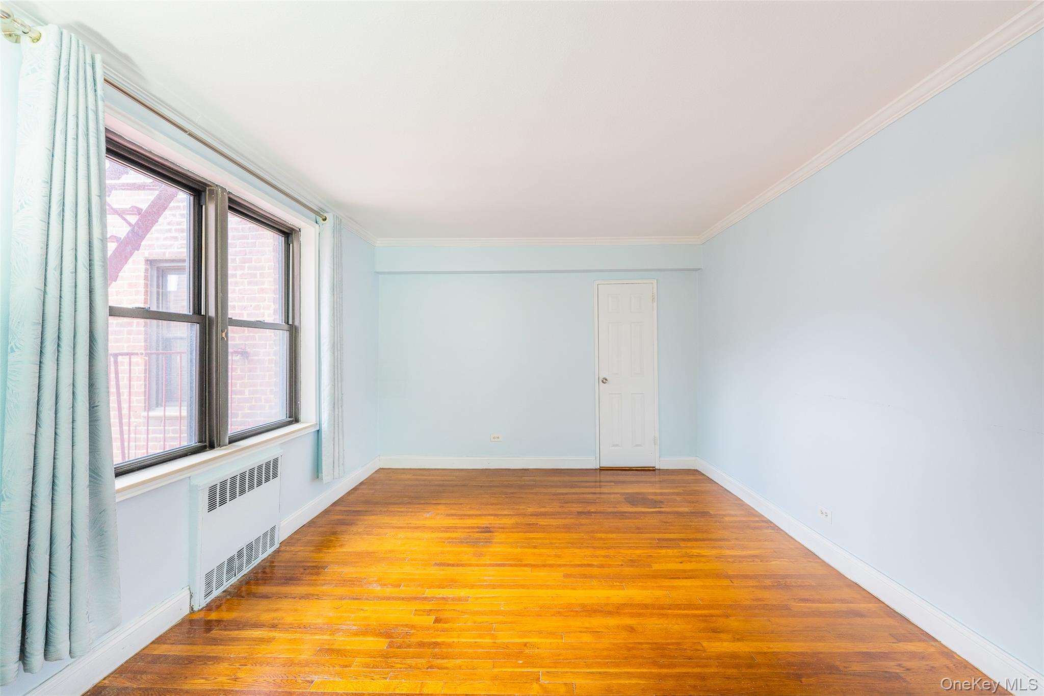 150-25 72nd Road, Unit 5K Queens, NY 11367 - Photo 6 of 21 a view of empty room with wooden floor