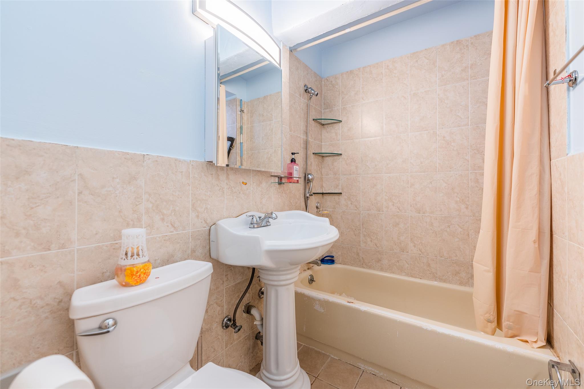 150-25 72nd Road, Unit 5K Queens, NY 11367 - Photo 9 of 21 a bathroom with a sink a toilet and bathtub