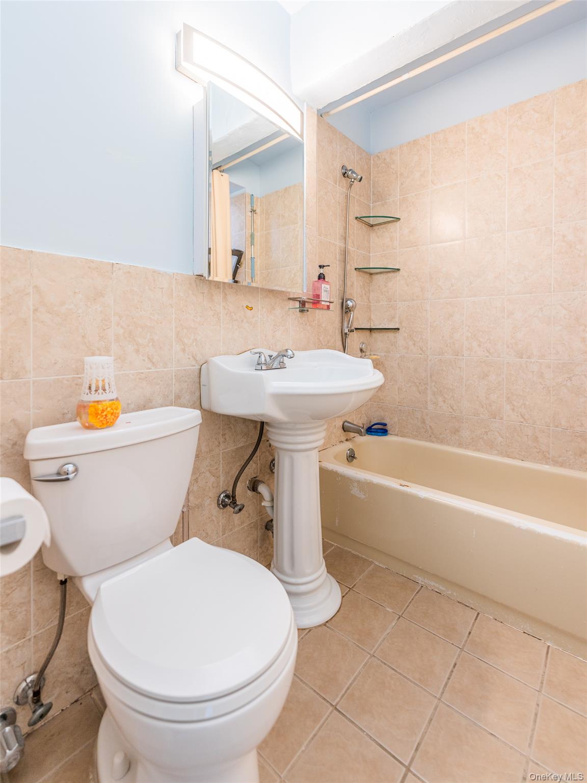 150-25 72nd Road, Unit 5K Queens, NY 11367 - Photo 10 of 21 a bathroom with a sink toilet and a bathtub
