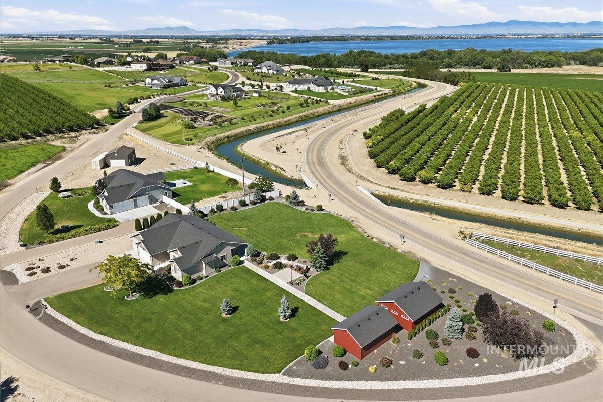 13496 Hockberger Ranch Road Caldwell, ID 83607 - Photo 5 of 40 Contemporary ranch-style home featuring a two-car garage, stone and stucco facade, and a dark shingled roof