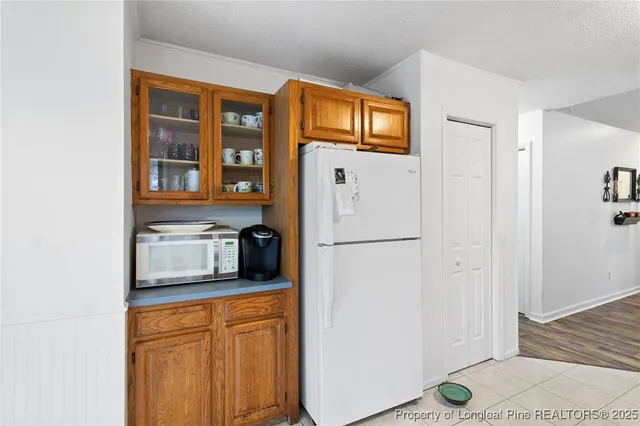 a kitchen with stainless steel appliances a refrigerator and a window