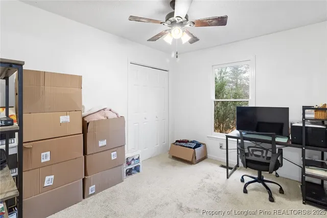 a bedroom with furniture and a chandelier fan
