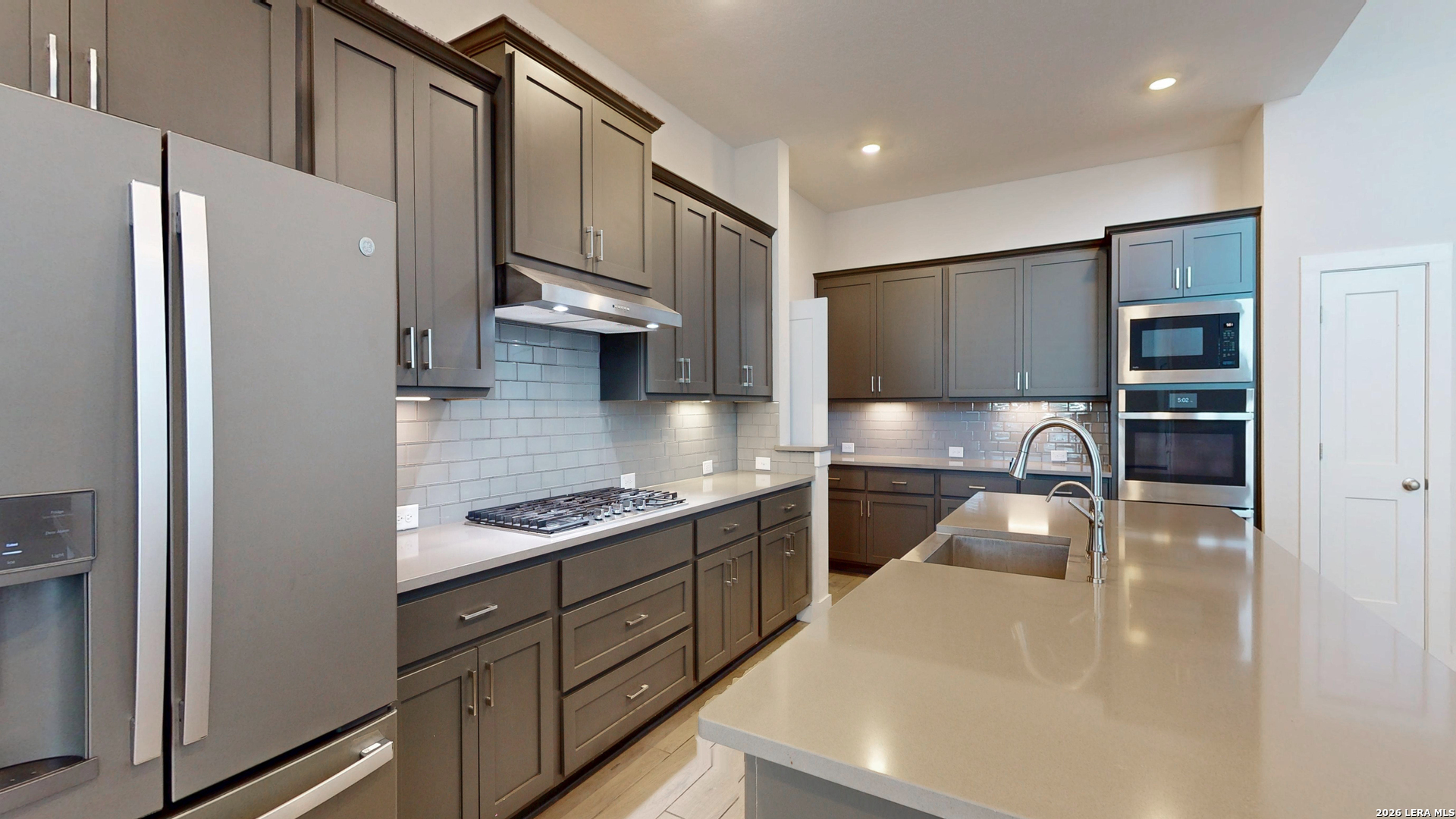 918 Rench New Braunfels, TX 78130 - Photo 11 of 41 a kitchen with stainless steel appliances granite countertop a refrigerator a sink and a stove