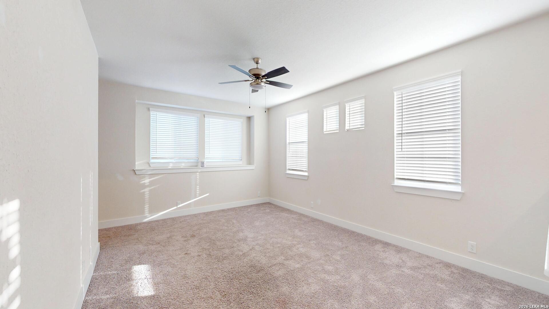 918 Rench New Braunfels, TX 78130 - Photo 31 of 41 an empty room with windows and chandelier fan