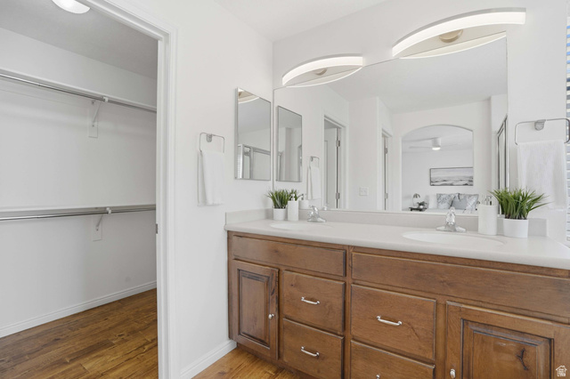 2007 Fielding Hill Lane Draper, UT 84020 - Photo 25 of 83 Dual sink vanity with wood-finish cabinetry and chrome hardware, featuring a large mirror with integrated lighting
