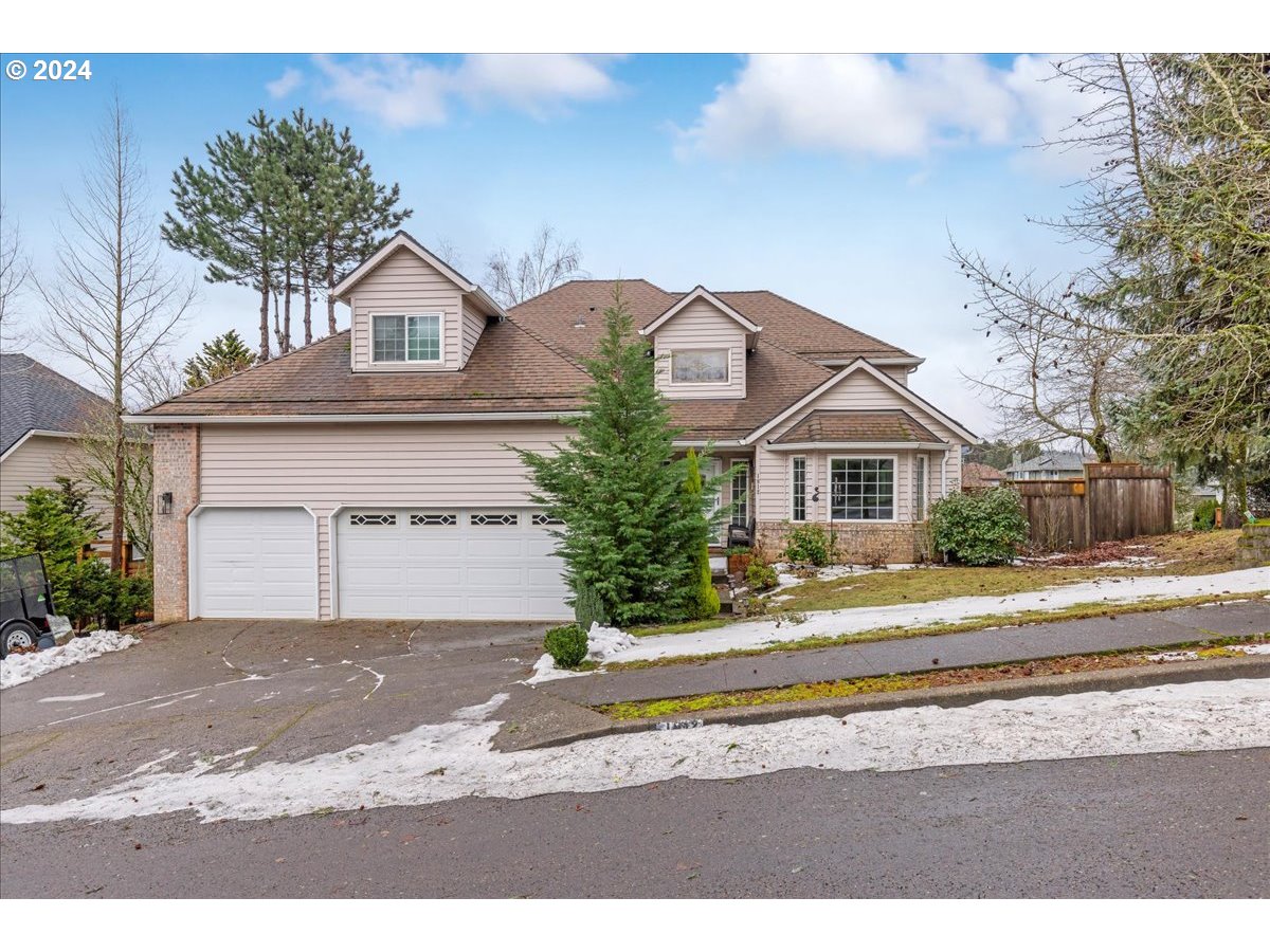 1812 Southwest Nancy Drive Gresham, OR 97080 - Photo 1 of 39 a view of a white house with a street and a yard