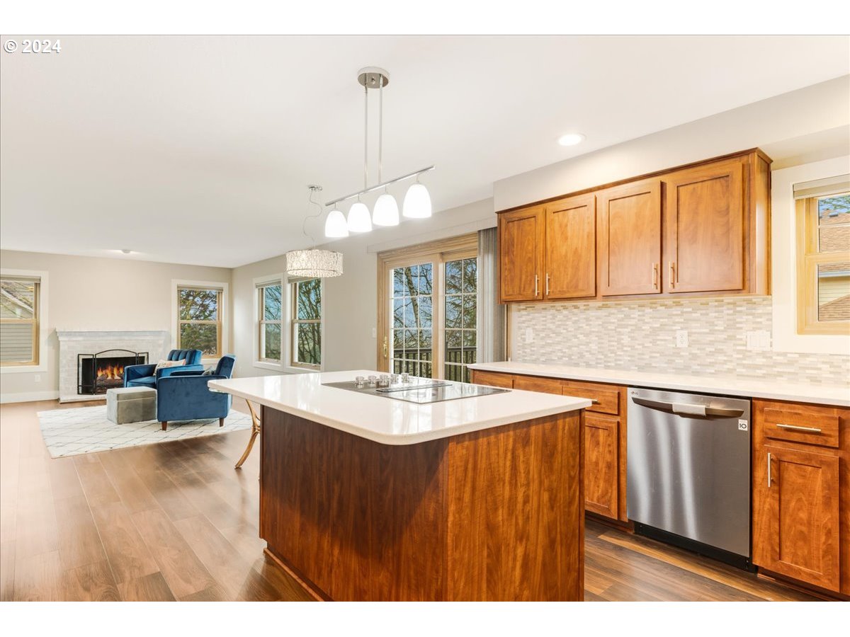 1812 Southwest Nancy Drive Gresham, OR 97080 - Photo 15 of 39 a open kitchen with stainless steel appliances granite countertop a sink dishwasher a stove with refrigerator a dining table and chairs with wooden floor