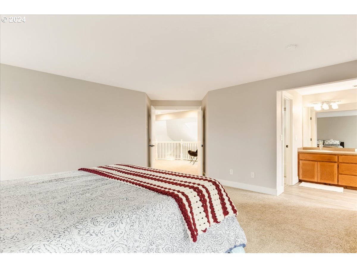1812 Southwest Nancy Drive Gresham, OR 97080 - Photo 23 of 39 a bedroom with a bed and a view of kitchen