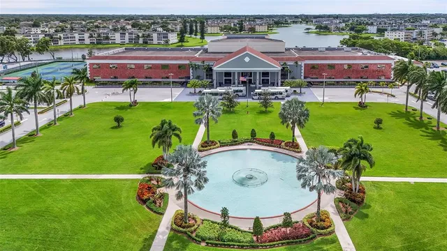 a view of swimming pool with a yard and lake view