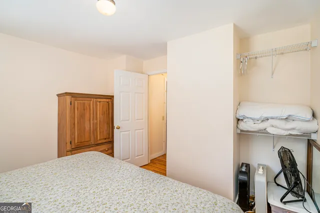 a bedroom with a bed and a bathroom