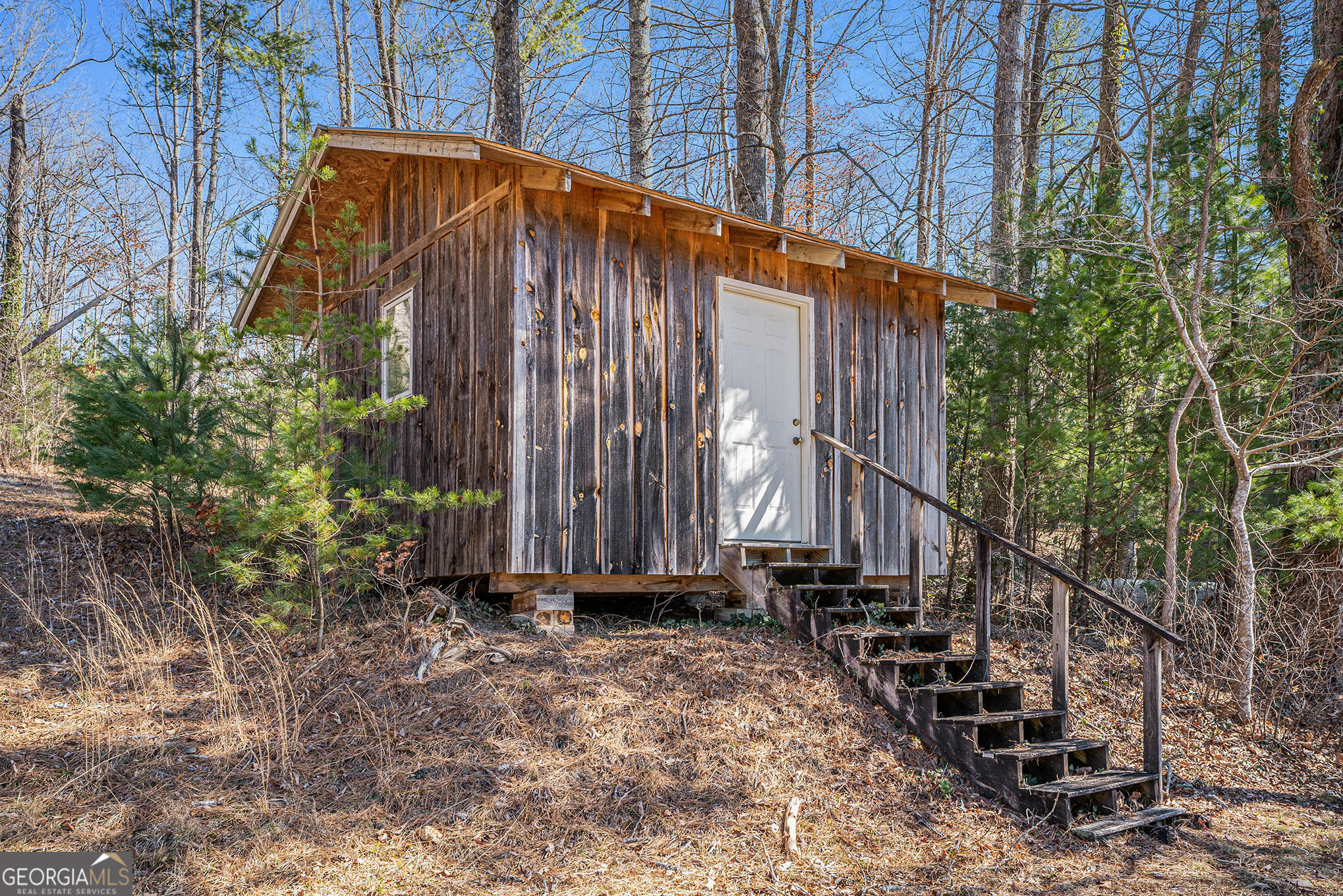 5622 Murray Cove Road Tiger, GA 30576 - Photo 26 of 39 a blue and white umbrella sitting in front of a yard