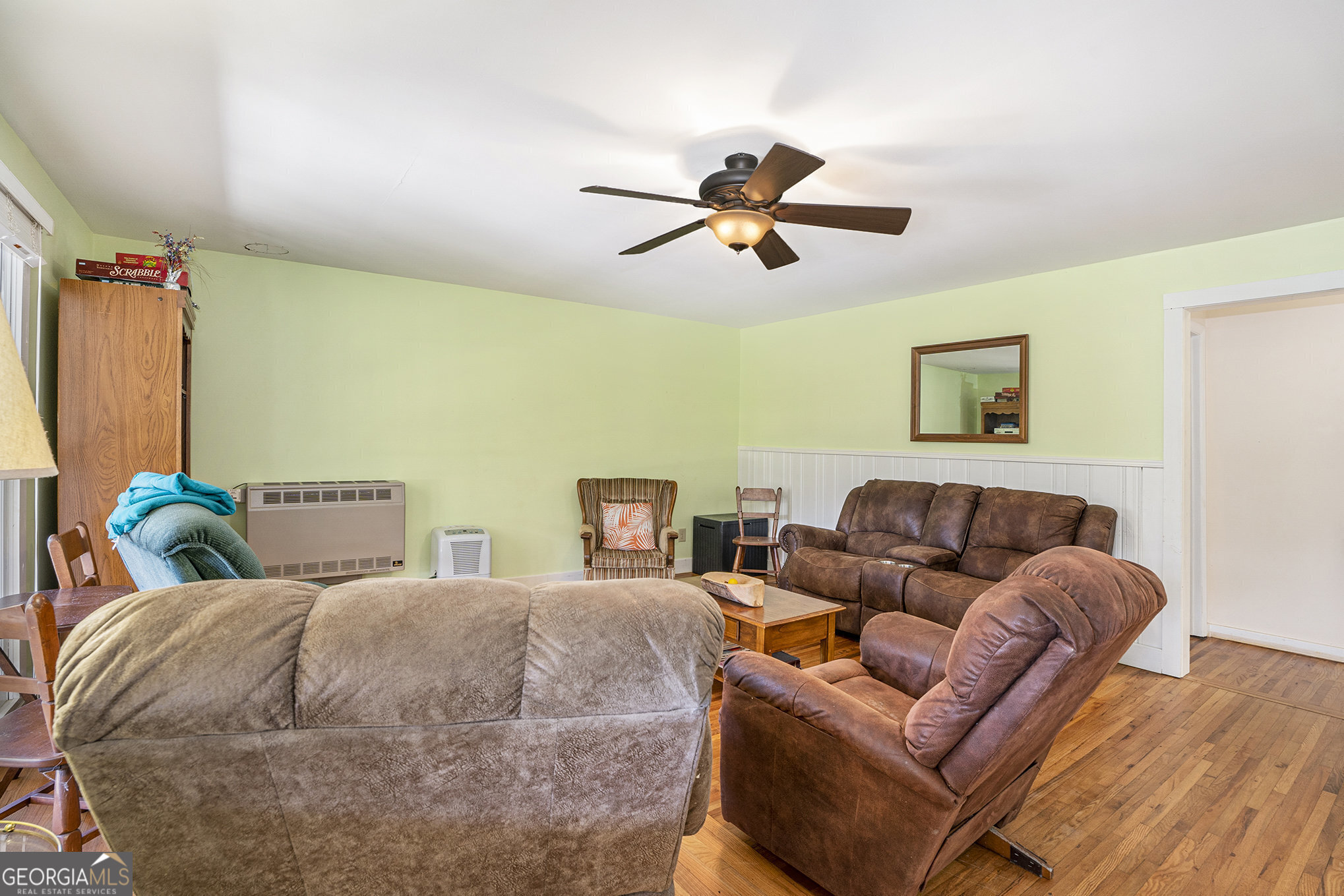 5622 Murray Cove Road Tiger, GA 30576 - Photo 7 of 39 a bed room with a bed a couch and a window