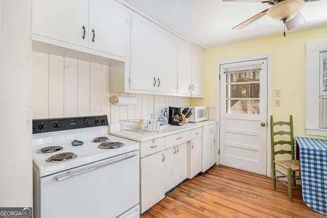 a kitchen with a stove a sink and a refrigerator