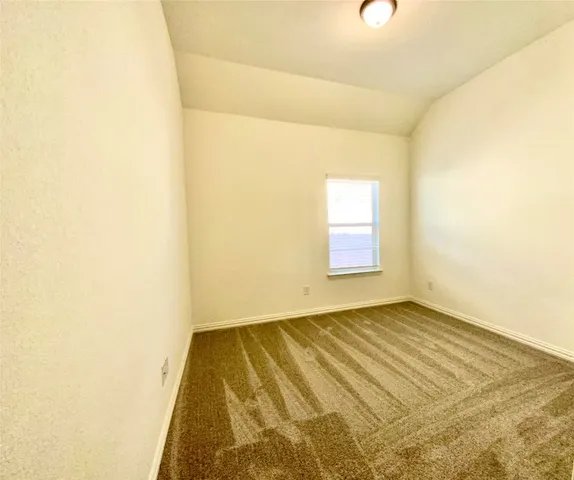 a view of a kitchen with granite countertop stainless steel appliances and a chandelier