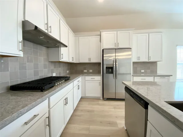 a bathroom with a tub shower and sink