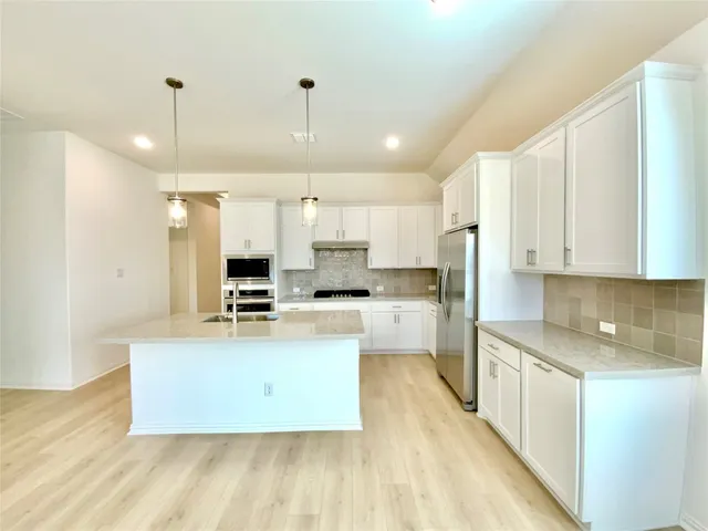 a bathroom with a tub sink shower and mirror