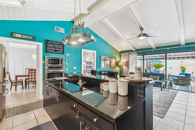 a large kitchen with stainless steel appliances kitchen island granite countertop a sink counter space and stainless steel appliances