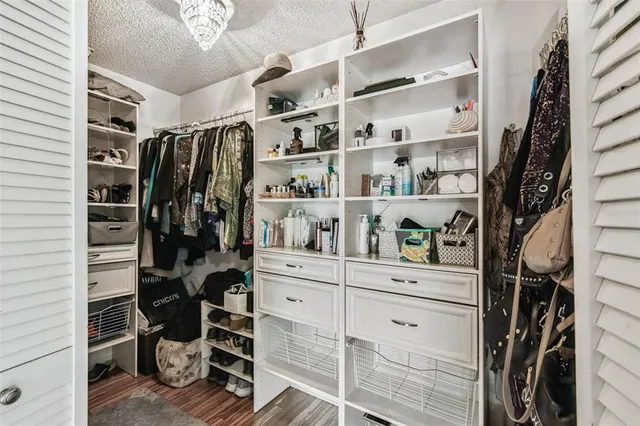 a bathroom with a granite countertop sink a toilet a mirror and shower