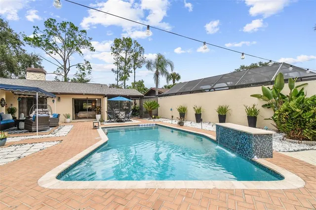 a view of a chair and table in backyard