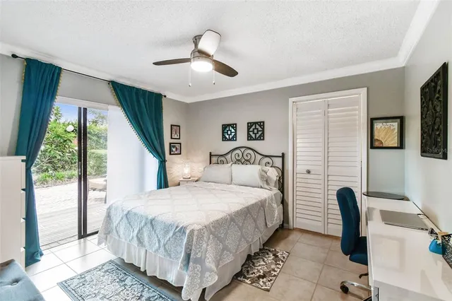 a view of a chair and tables in the back yard of the house