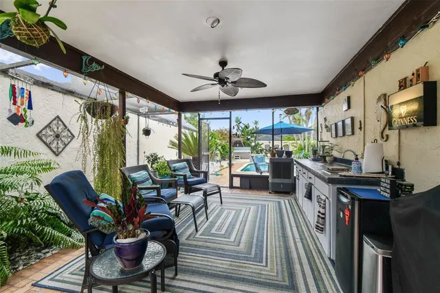 an aerial view of a house with swimming pool and outdoor seating